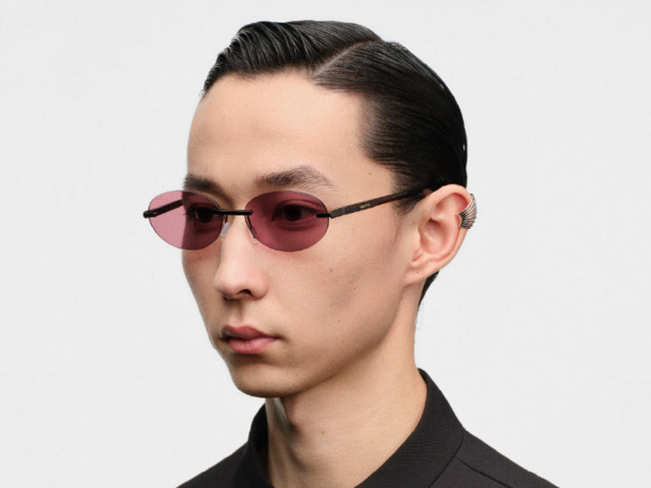 Model wearing MUJOSH retro round sunglasses in profile, the lens sitting clear of the cheek