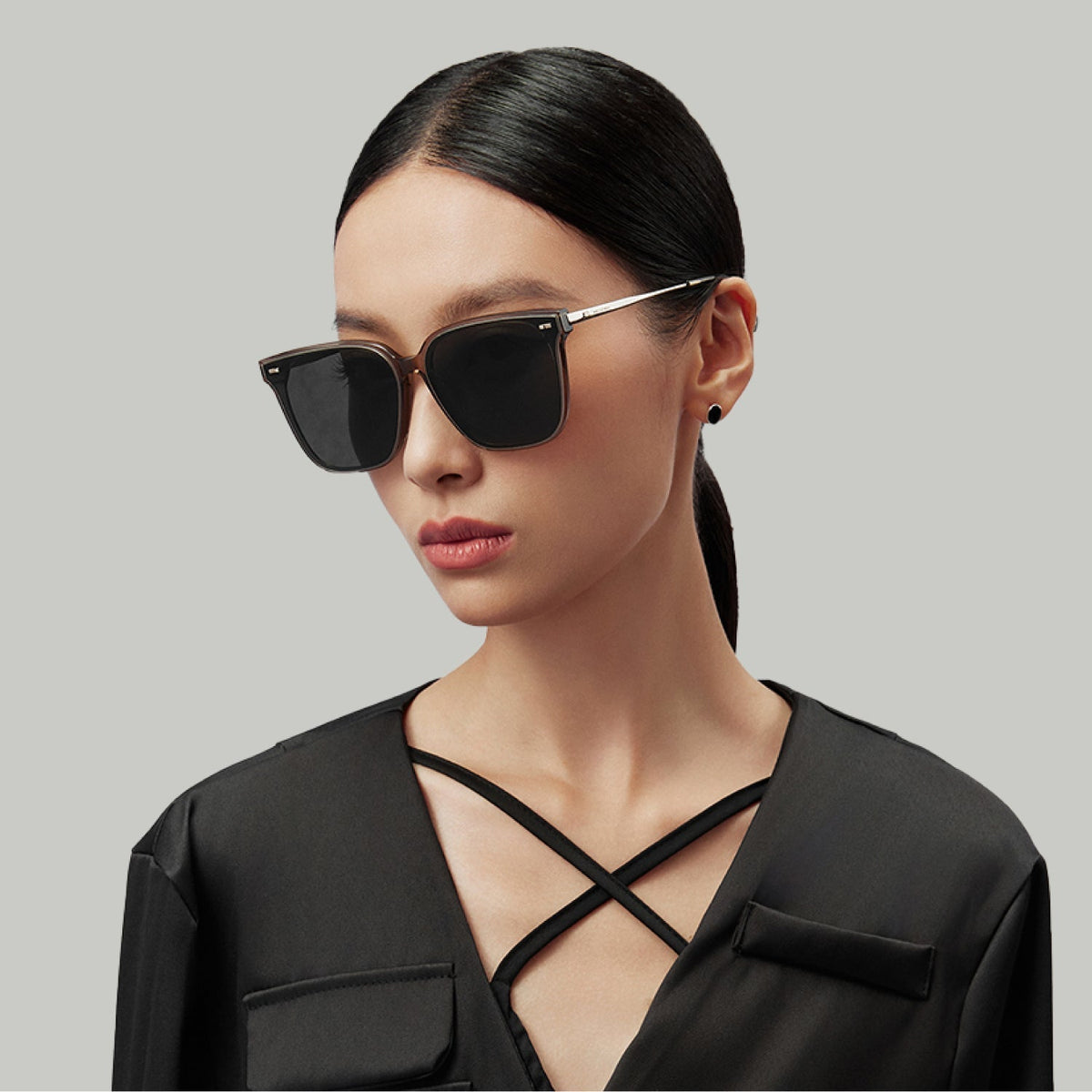 Model wearing MUJOSH oversized square sunglasses with dark lenses and thin metal temples